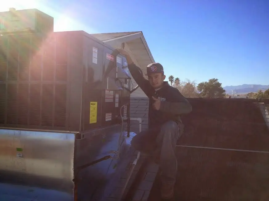 HVAC technician performing Boiler Repair on a rooftop unit in Arcadia